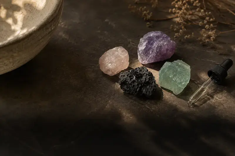 Unpolished ritual stones with a fragrance oil dropper